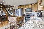 Kitchen with stainless steel appliances and everything needed to cook.